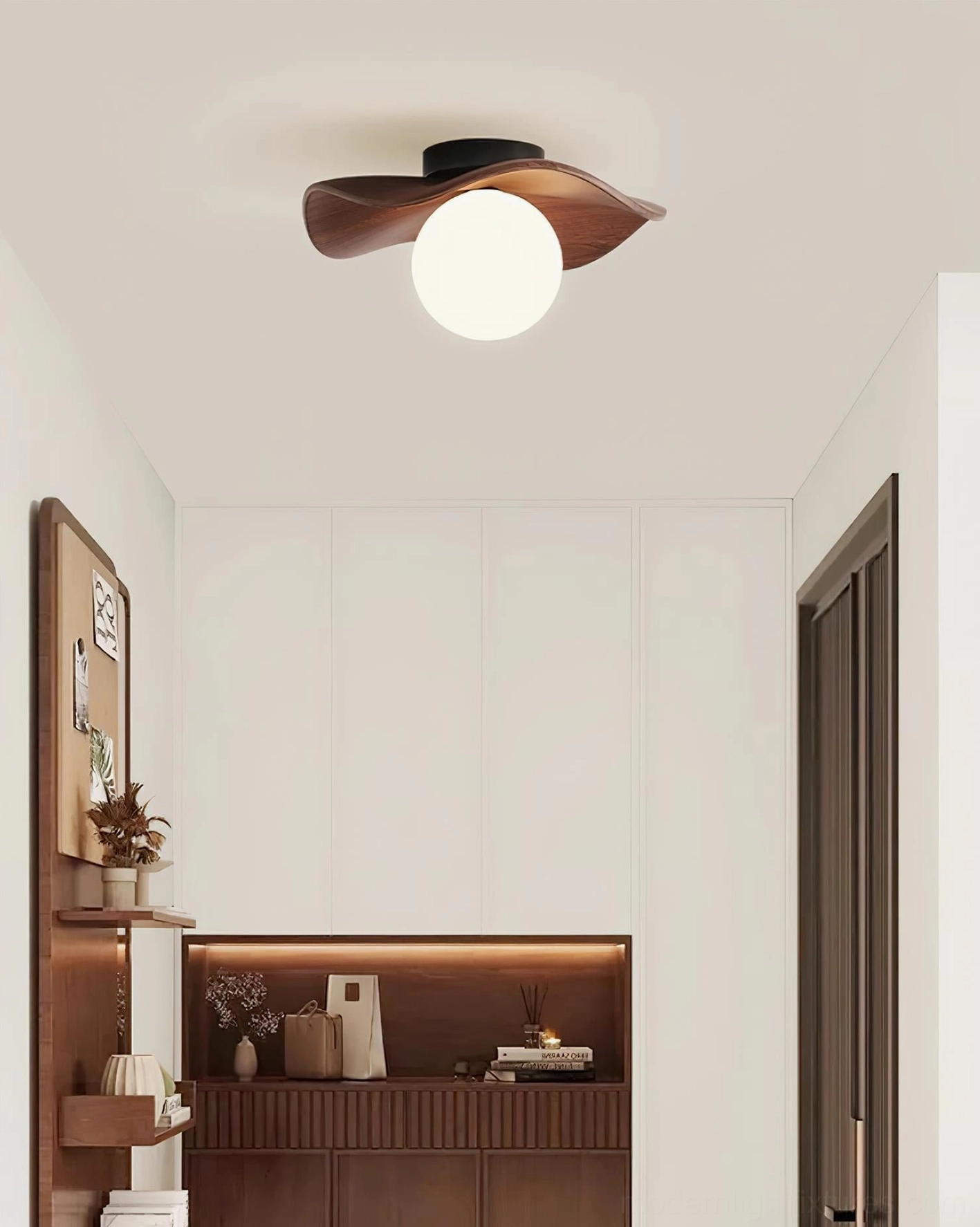 Gand ceiling fixture installed above entryway showing design sophistication and proportion