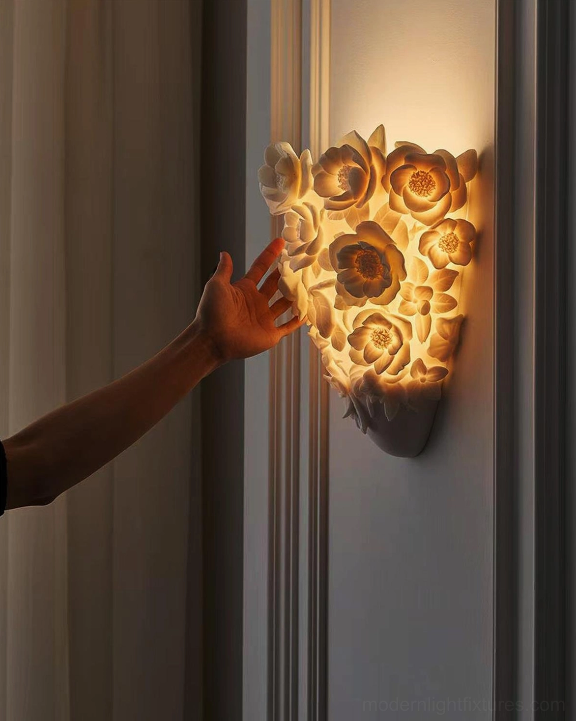Gardenia wall sconce illuminated with hand interaction, warm ambient lighting in interior space