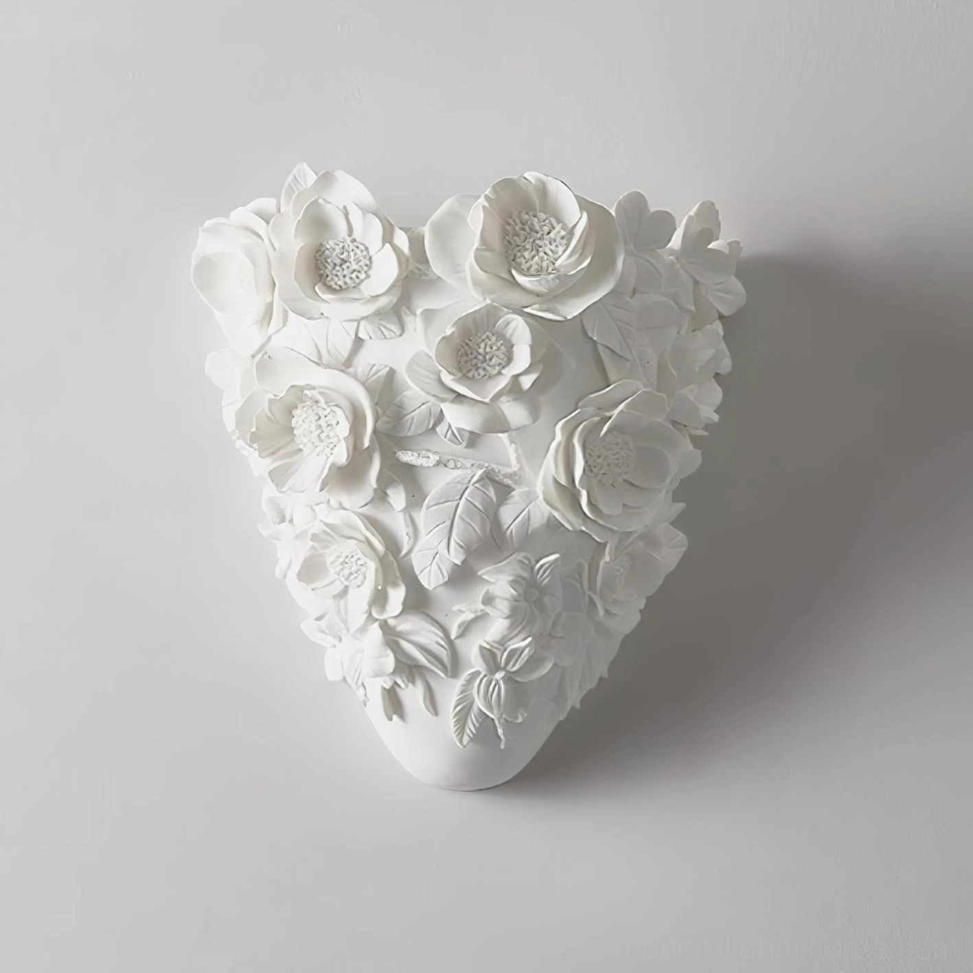 Gardenia sculptural wall sconce front illuminated view, warm white 3000K LED lighting effect