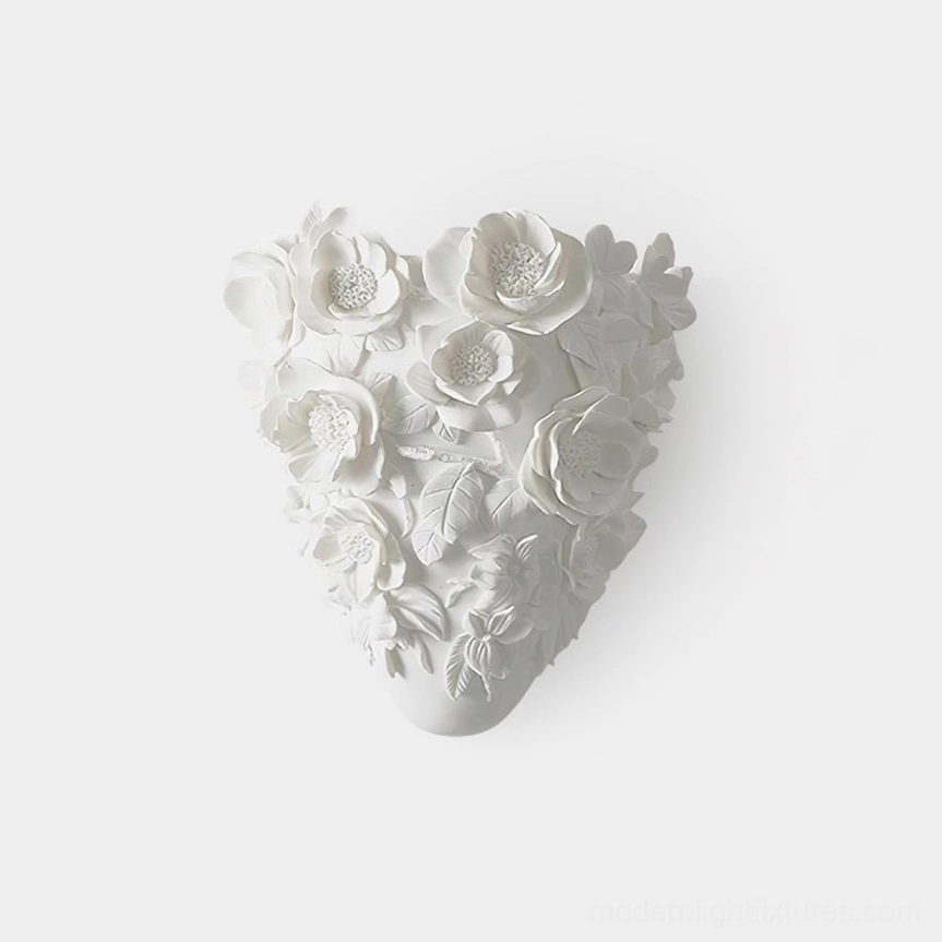 Gardenia porcelain wall sconce with sculptural floral relief, front view on white background