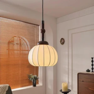 Modern silk pendant lamp hanging in retro home space with wooden window blinds creating warm ambient glow effect