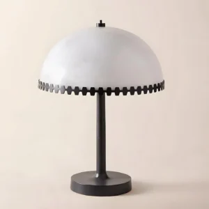 Paired Gearline table lamps as matching bedside lighting in contemporary master bedroom with upholstered bed frame