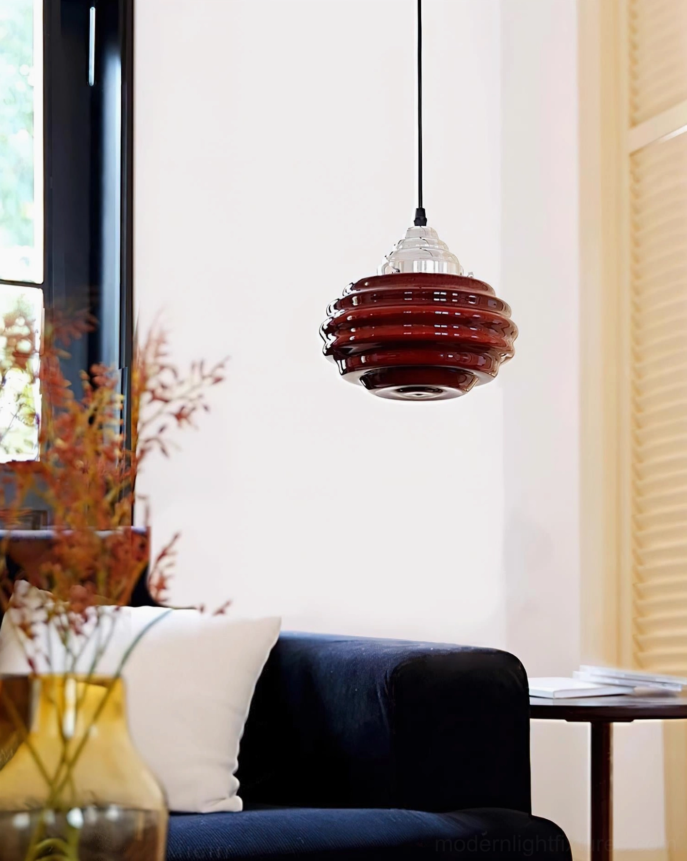 Gelato pendant lamp installed above kitchen island or dining area demonstrating warm ambient illumination and mid-century modern aesthetic