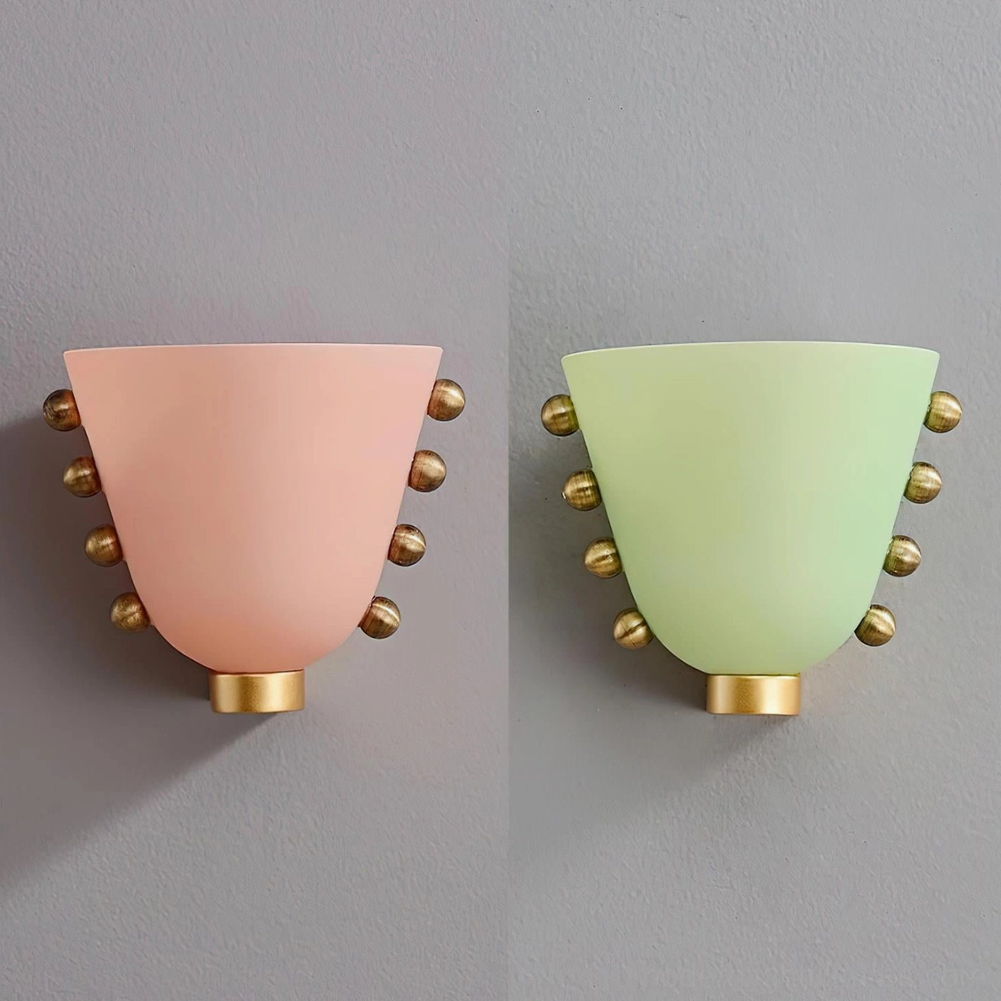 Pair of Gemma wall sconces in pink and mint green frosted glass with brass accents, studio display