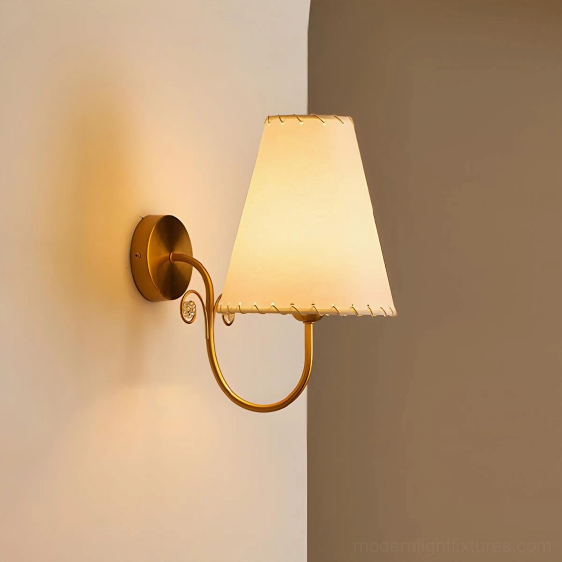 Gentle Bend wall sconce modern curved brass arm with crystal accents off-white fabric shade detail