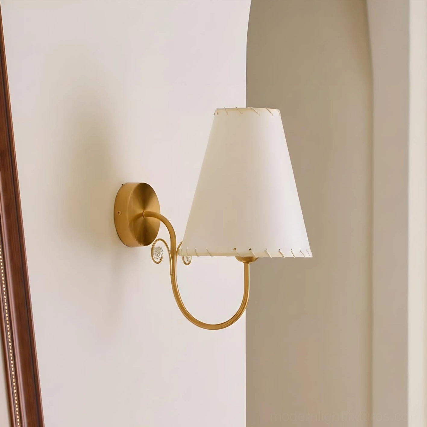 Gentle Bend wall sconce product view neutral wall backdrop off-white fabric shade brass hardware