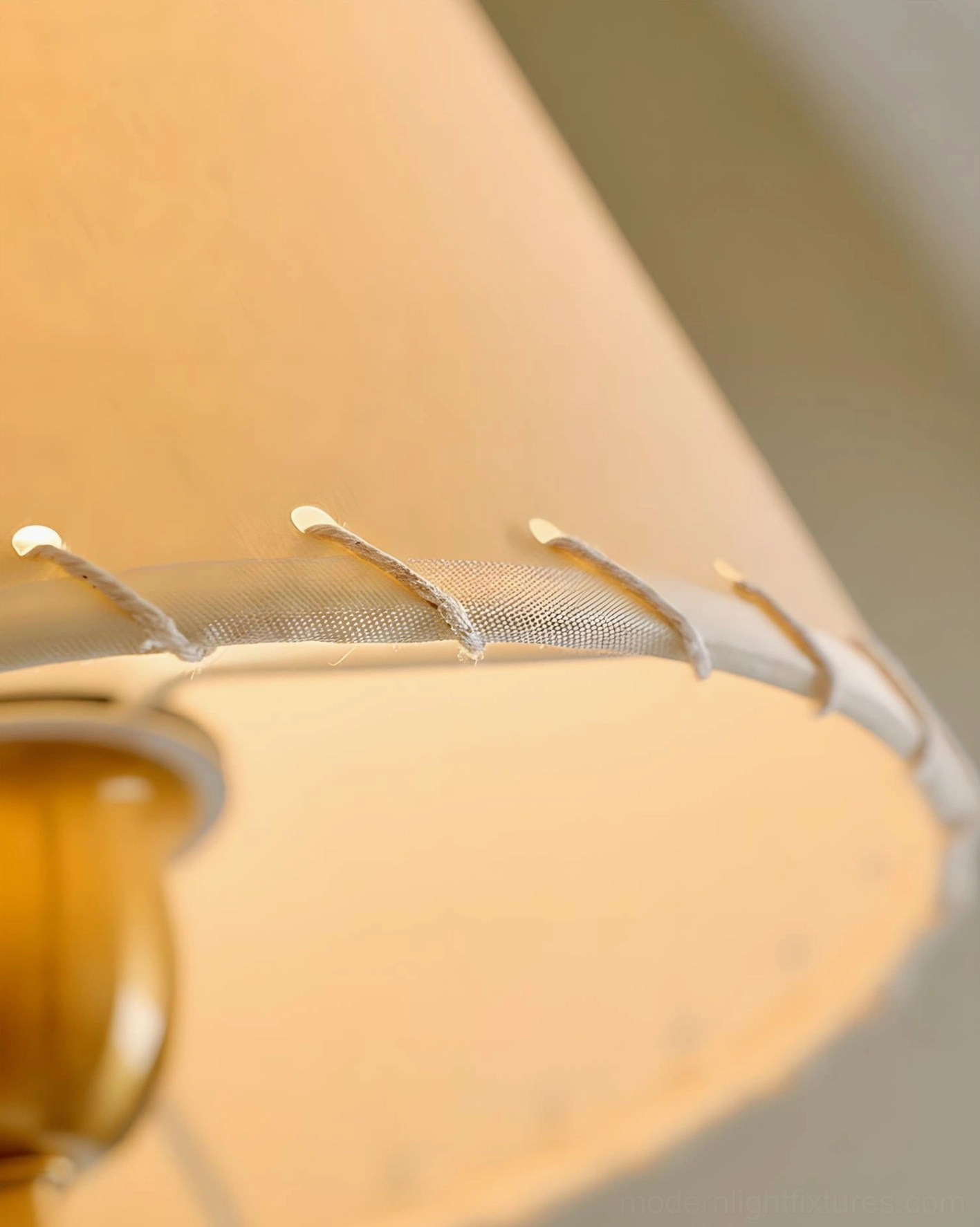 Gentle Bend fabric wall sconce side profile view showing curved brass arm and shade construction
