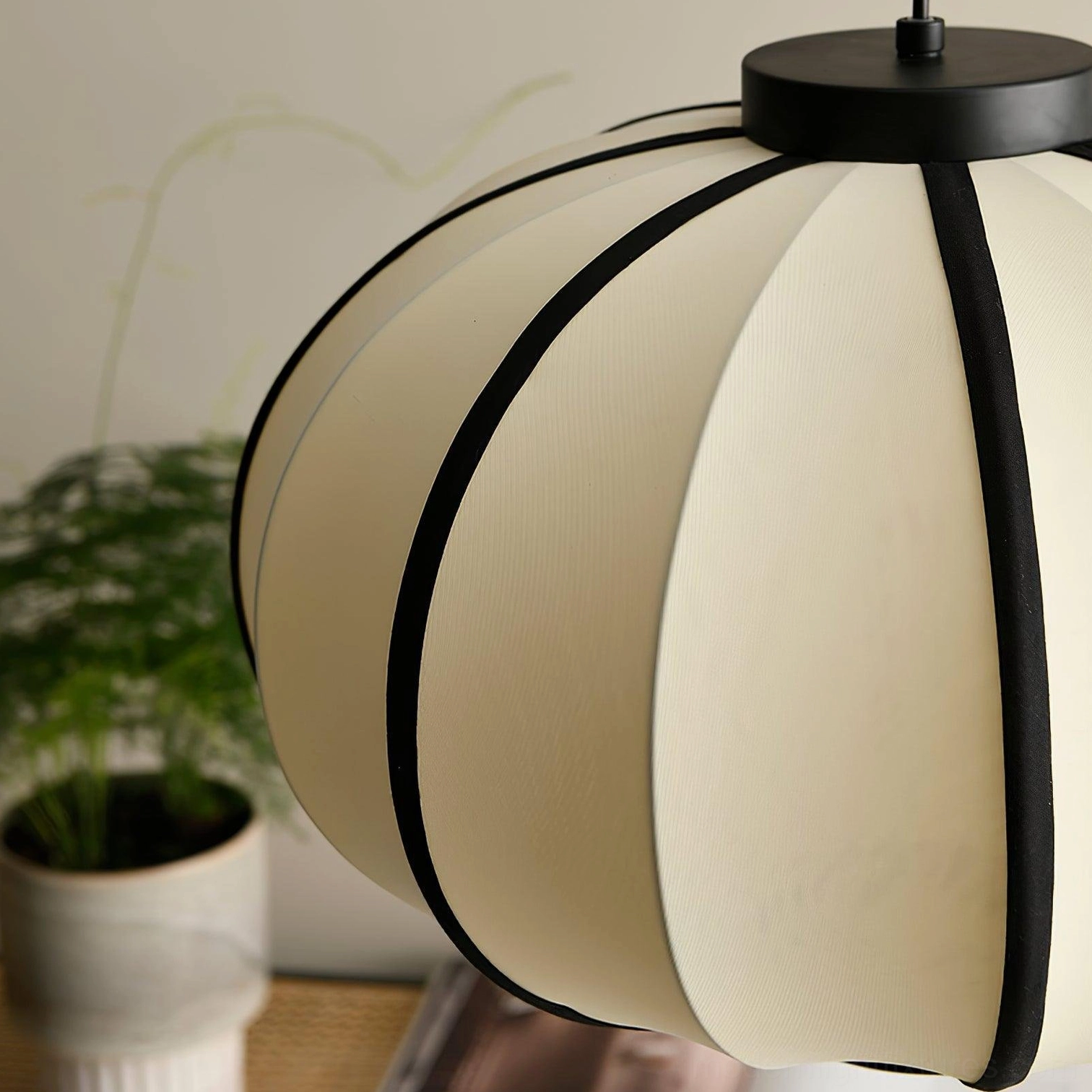 Geometric black and white fabric lantern pendant light modern design aesthetic close-up