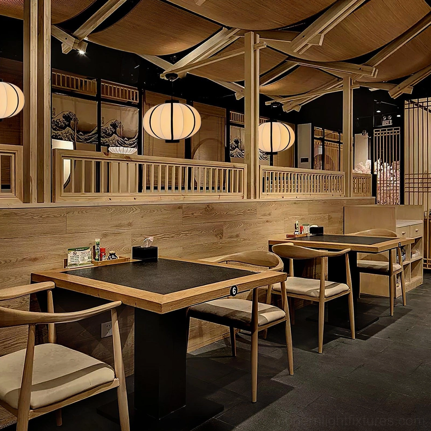 Multiple modern geometric lantern pendants in Japanese izakaya restaurant setting with wooden ceiling
