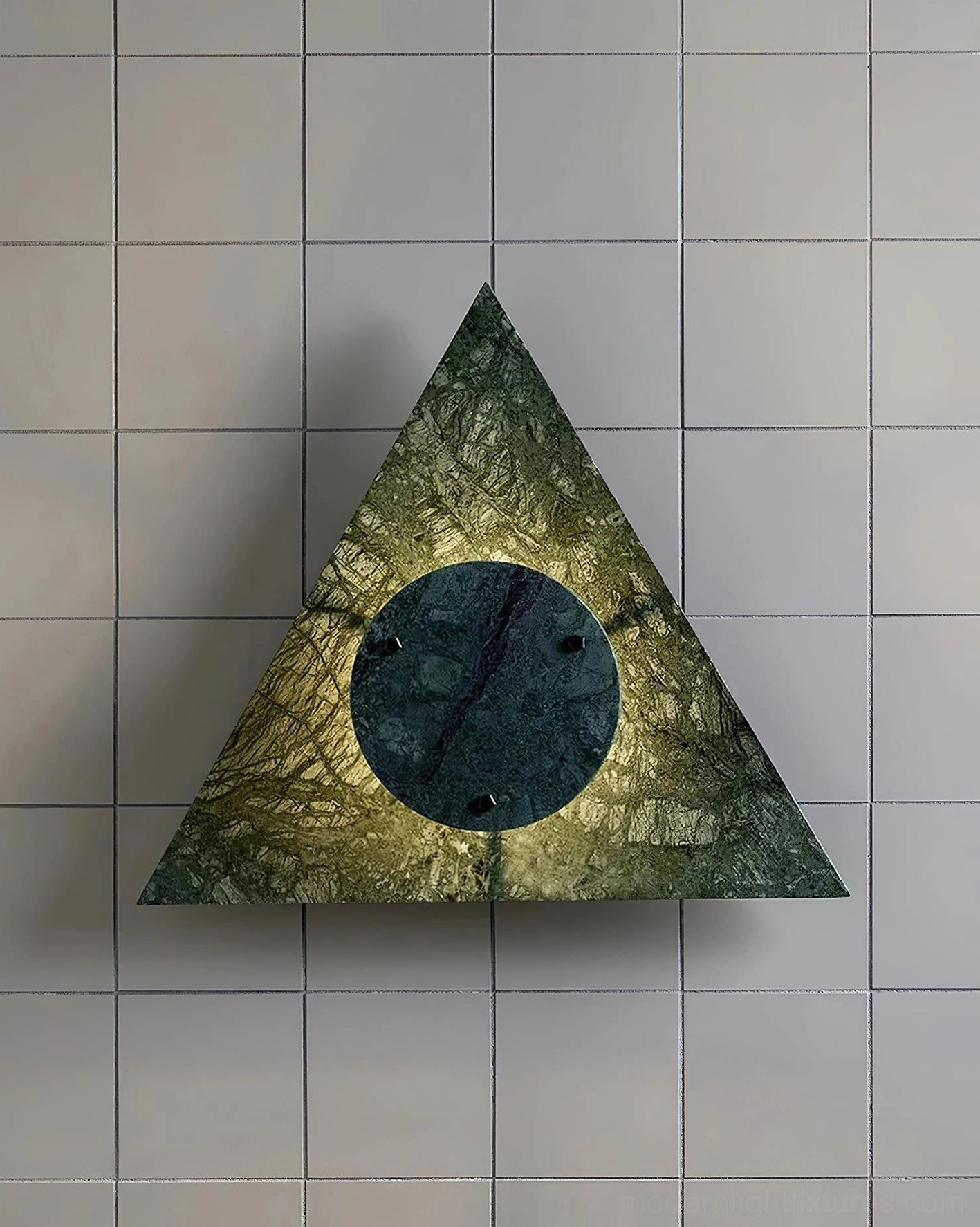 Yellow-green marble wall sconce with triangular design on light gray tiled wall