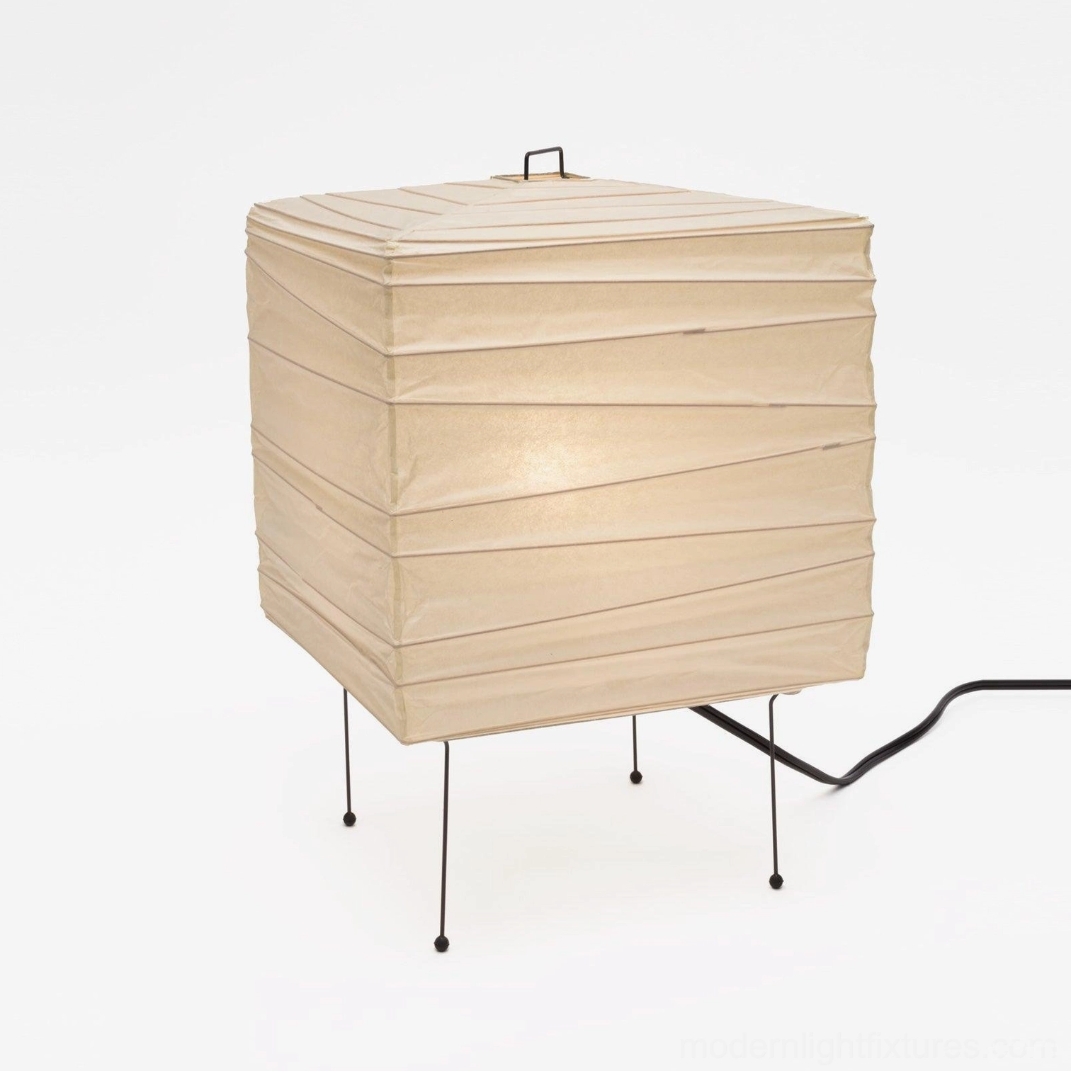Modern minimalist paper cube lamp with black metal legs unlit product photography