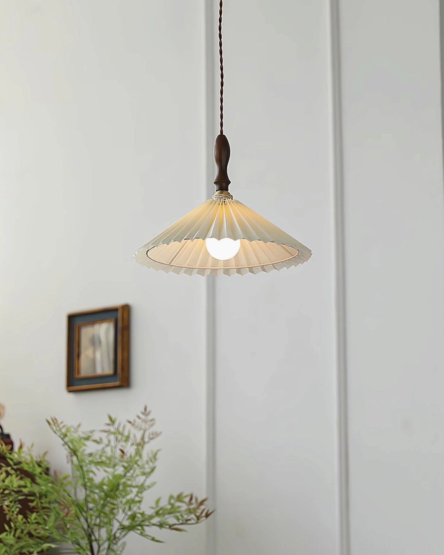 Minimalist pleated pendant light with geometric fabric shade in corner wall installation