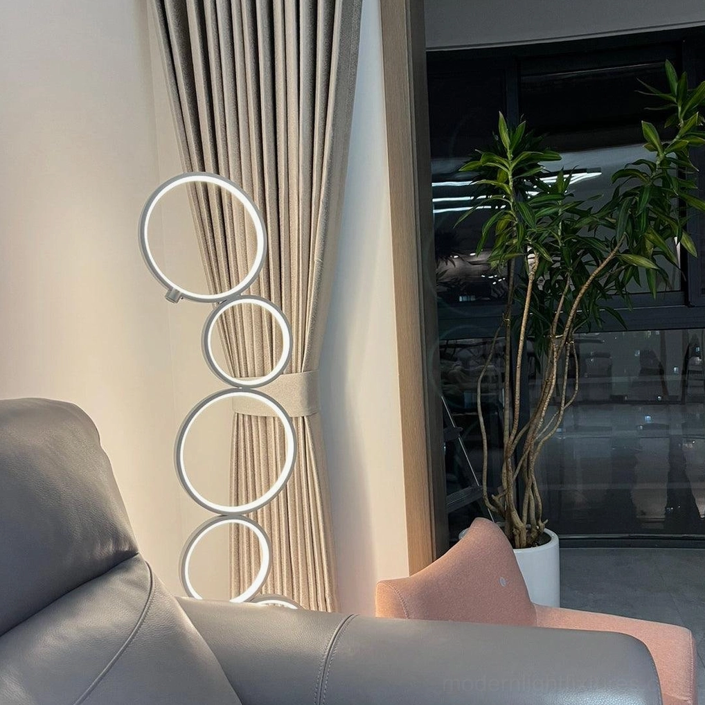 Modern geometric ring floor lamp sculptural form in matte black finish with LED illumination