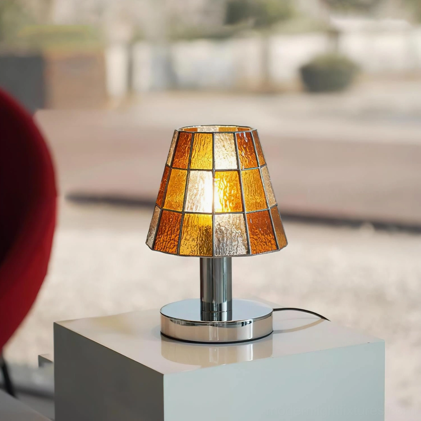 Geometric stained glass table lamp with polished chrome base and contemporary artistic design elements