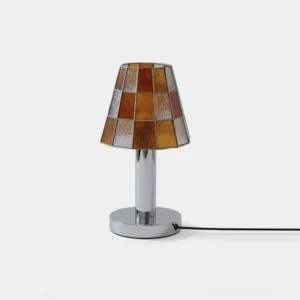 Modern stained glass table lamp with geometric mosaic tiles and chrome base, front view on white background