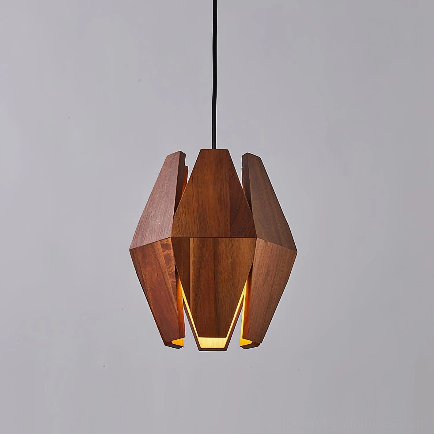 Geometric faceted wood pendant light close-up showing polygonal design and warm illumination