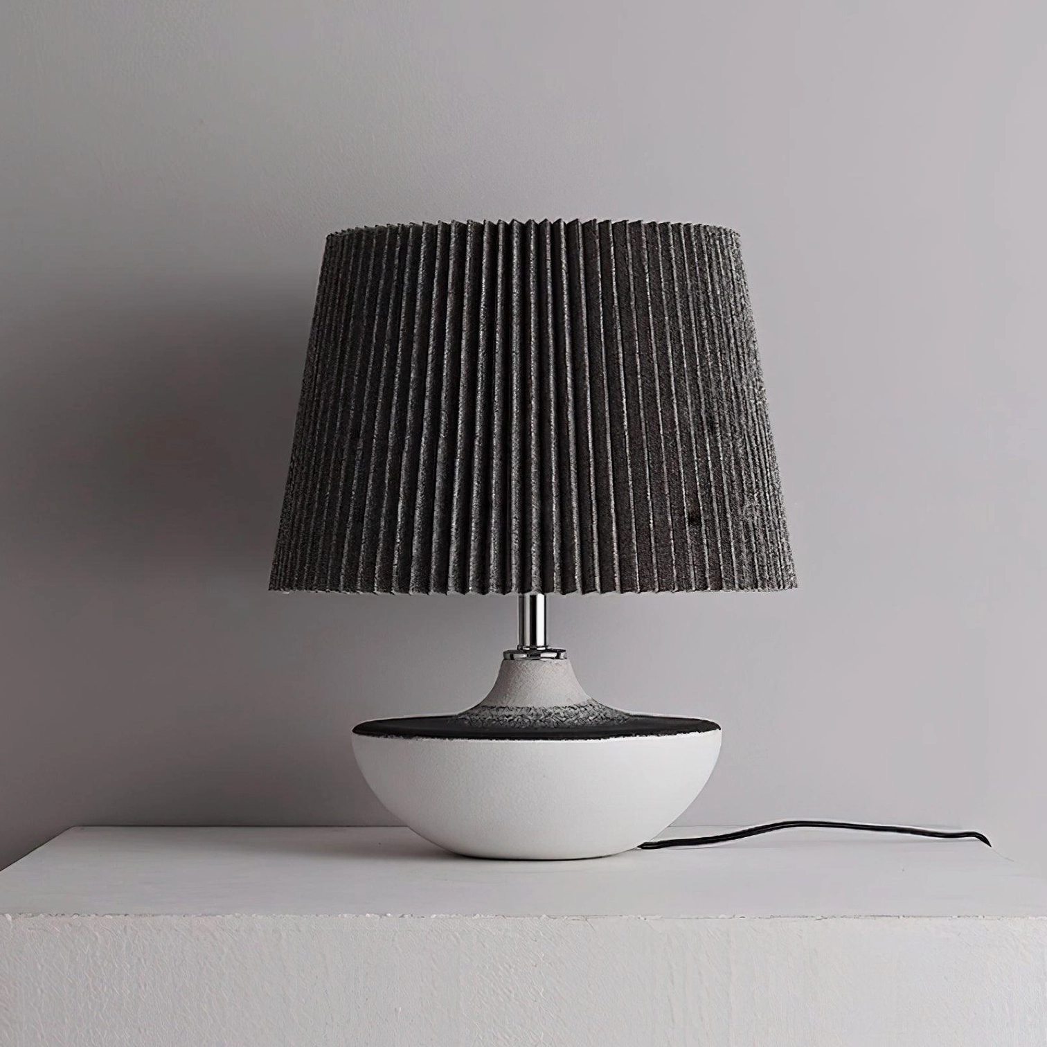 Ghassan modern ceramic table lamp with pleated shade creating soft diffused light and warm glow