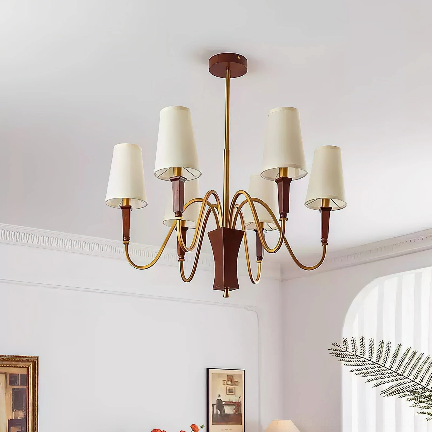 Gianna 6-light chandelier in minimalist vintage living room with warm brass finish and off-white fabric shades