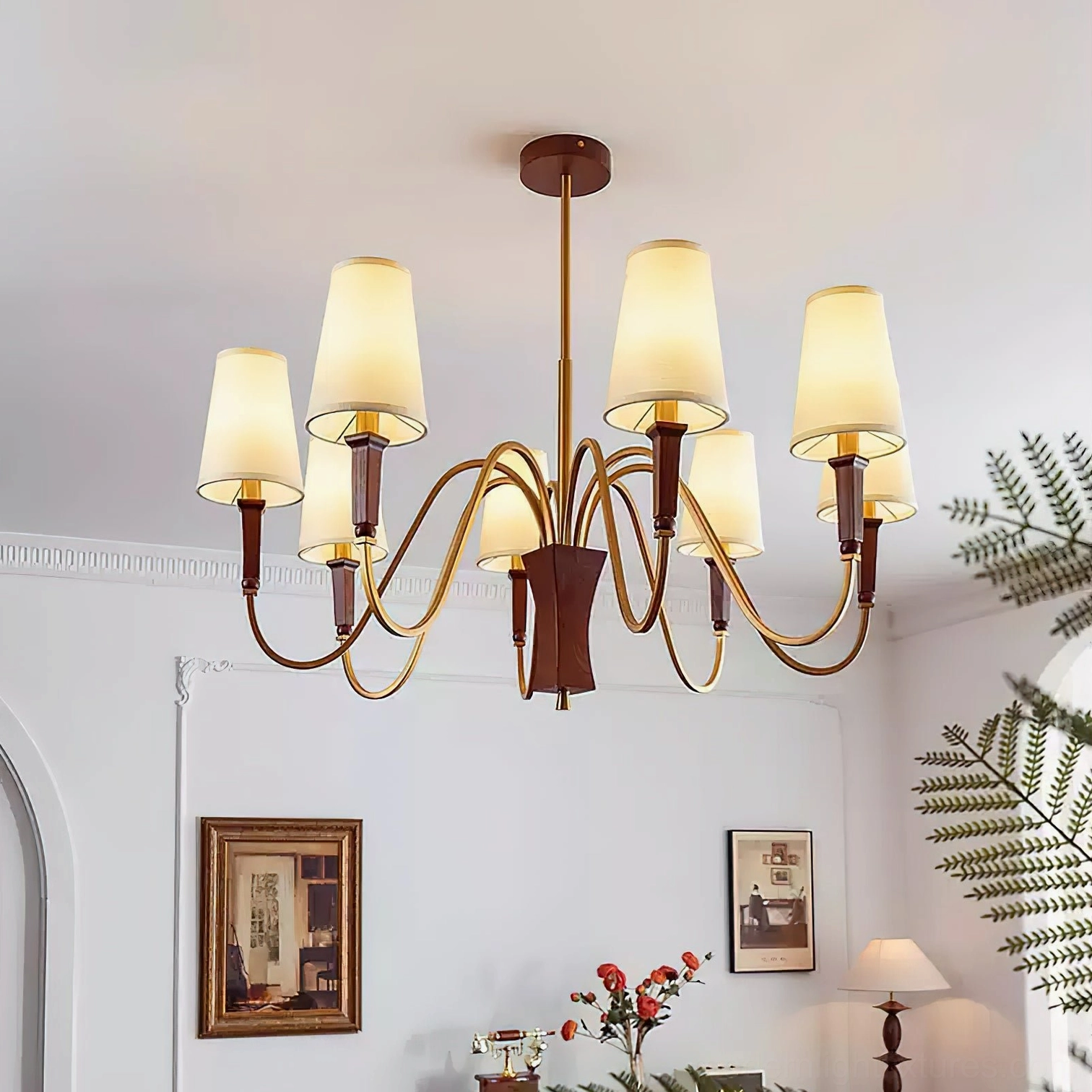 Multi-head Gianna chandelier installed in vintage European living room with warm brass finish and off-white fabric shades