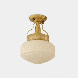 Gilded Prism semi-flush ceiling light with carved geometric glass shade and brass canopy, front studio view