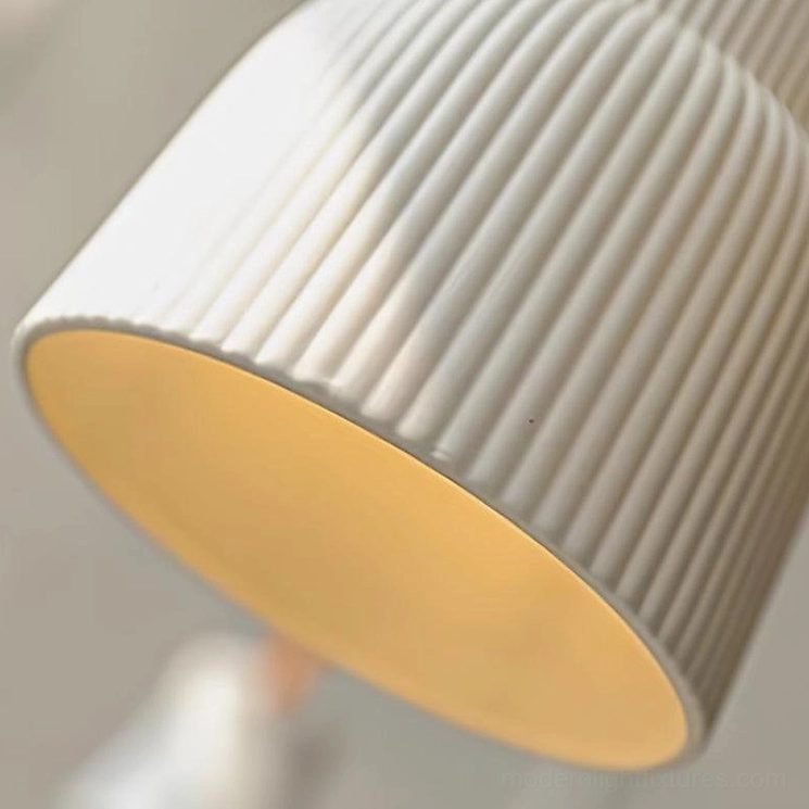 Artisanal ceramic pendant light with handcrafted ridged texture and organic design in contemporary home setting