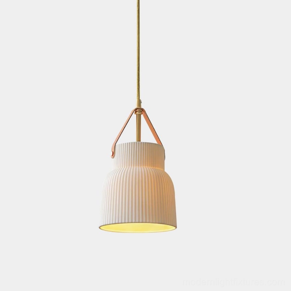 Gina ridged ceramic pendant light front view studio shot showing textured white shade with brass top and tan leather suspension strap