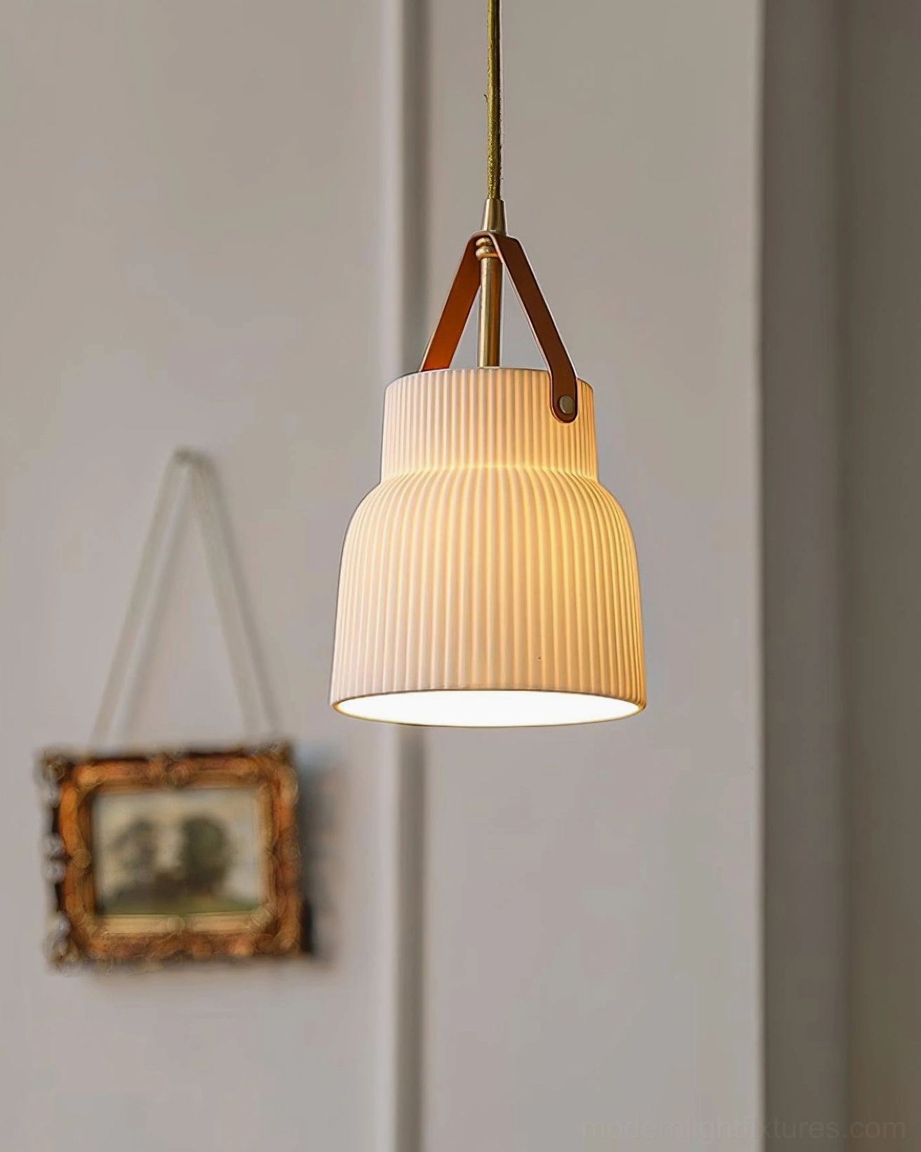 Modern handcrafted ceramic pendant lamp with ridged surface detail and brass mounting hardware close-up