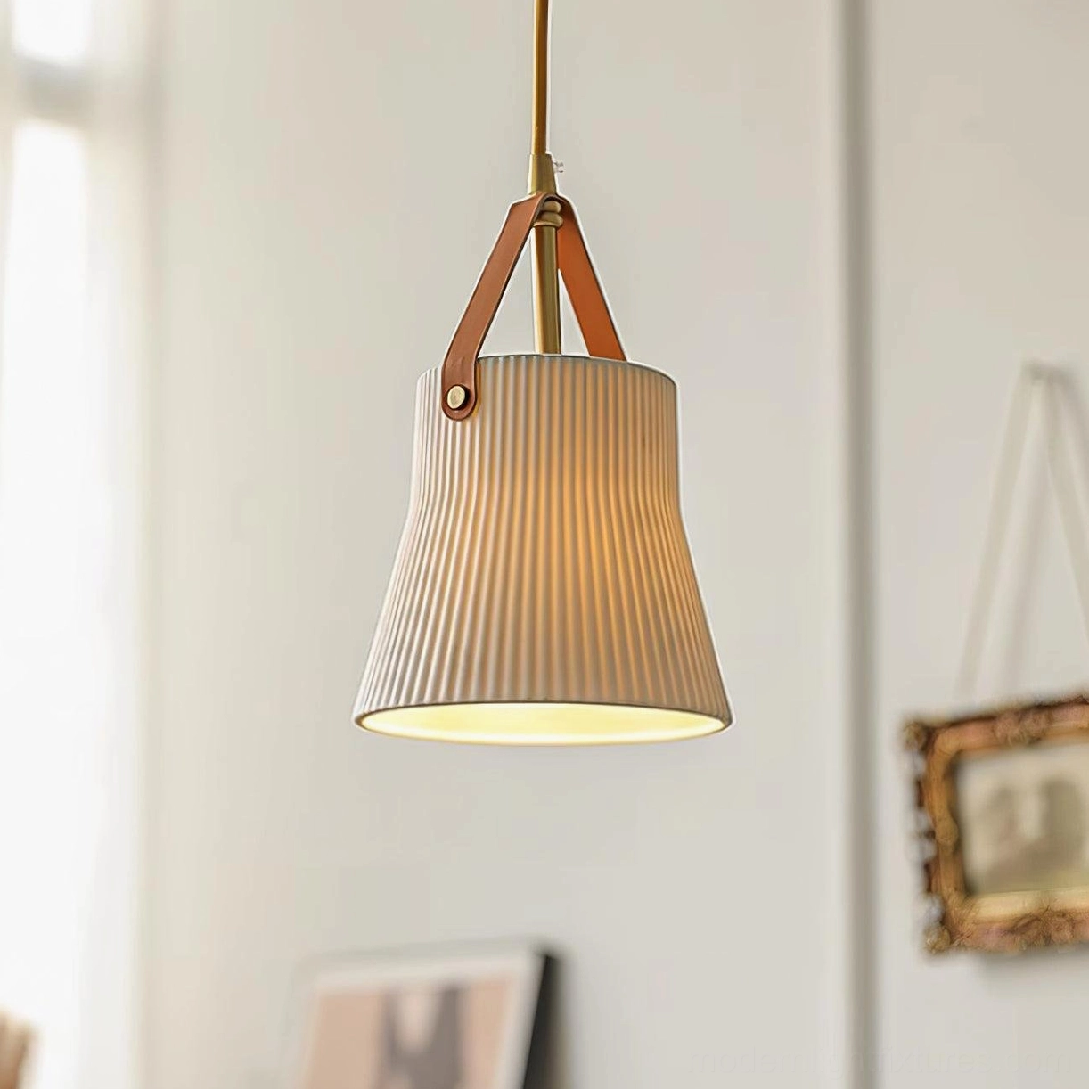 Gold and white ceramic pendant light showing brass accents and ridged ceramic shade in minimalist setting