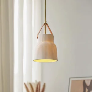 Modern ceramic ridged pendant lamp glowing warm light in Nordic minimalist interior with white curtains