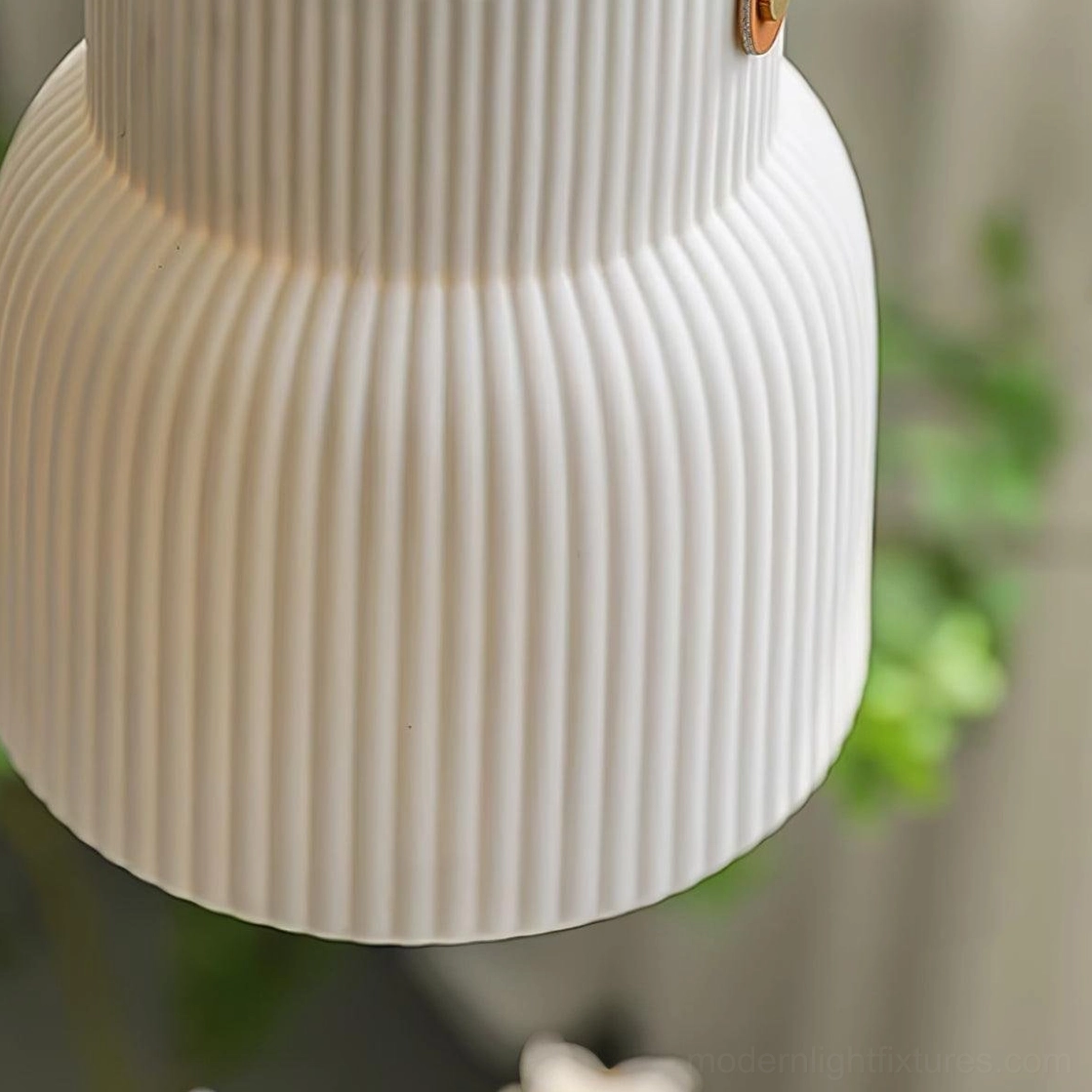 Scandinavian style ceramic ridged pendant lamp creating hygge atmosphere in modern Nordic interior space