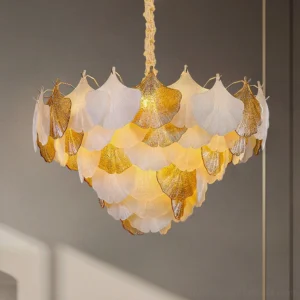Close-up detail of ginkgo chandelier glass petals showing frosted white and glitter gold textures with twisted gold hanging rod