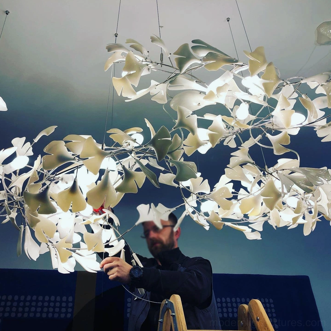 Modern ginkgo leaf pendant chandelier illuminated in hotel lobby and luxury commercial atrium
