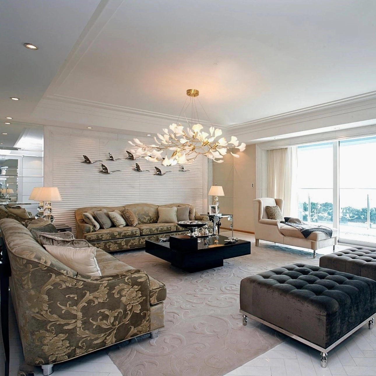 Contemporary ginkgo leaf chandelier installed in luxury residential living room above seating area