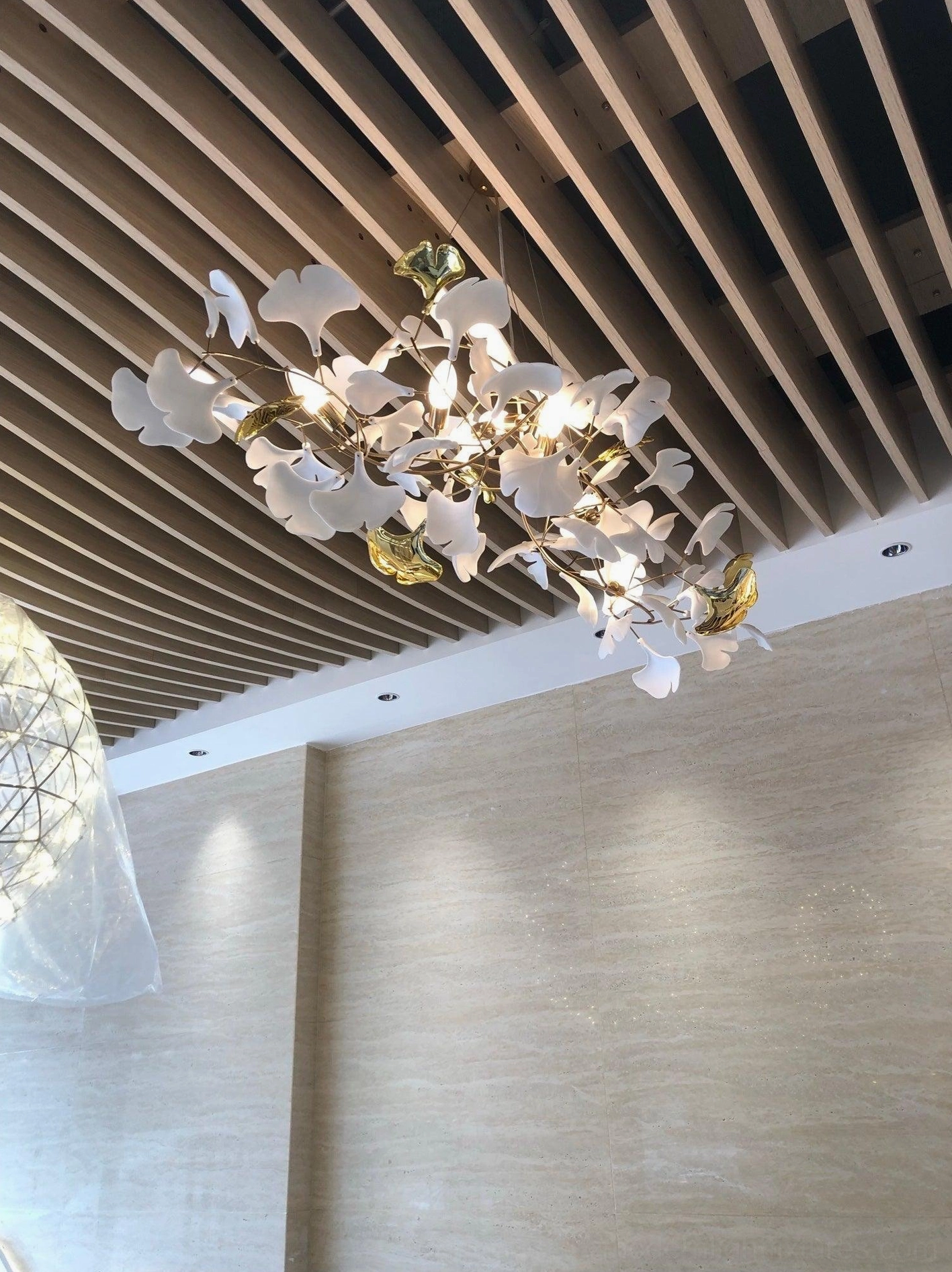 Medium ginkgo leaf chandelier 120cm size with ten ceramic leaves suspended from flexible metal frame