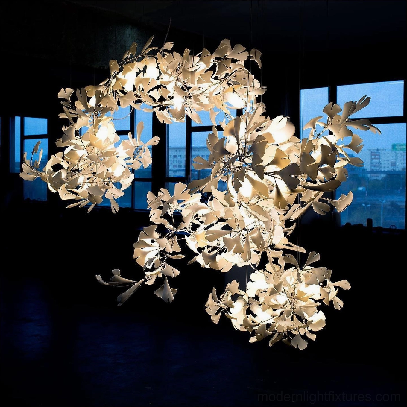 Contemporary ginkgo leaf pendant chandelier in mid-century modern interior with eames-era furniture