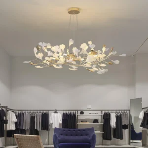Ginkgo leaf pendant chandelier installed in luxury retail boutique with warm illuminated lighting and contemporary ambiance
