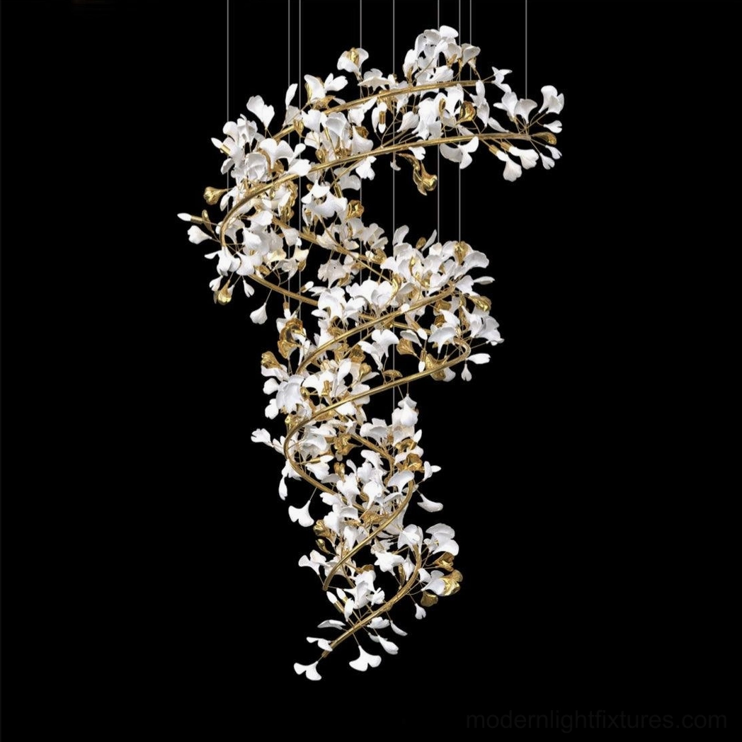 Dense spiral structure ginkgo leaf chandelier with gold frame and clear crystal leaves on black studio background, modern luxury lighting