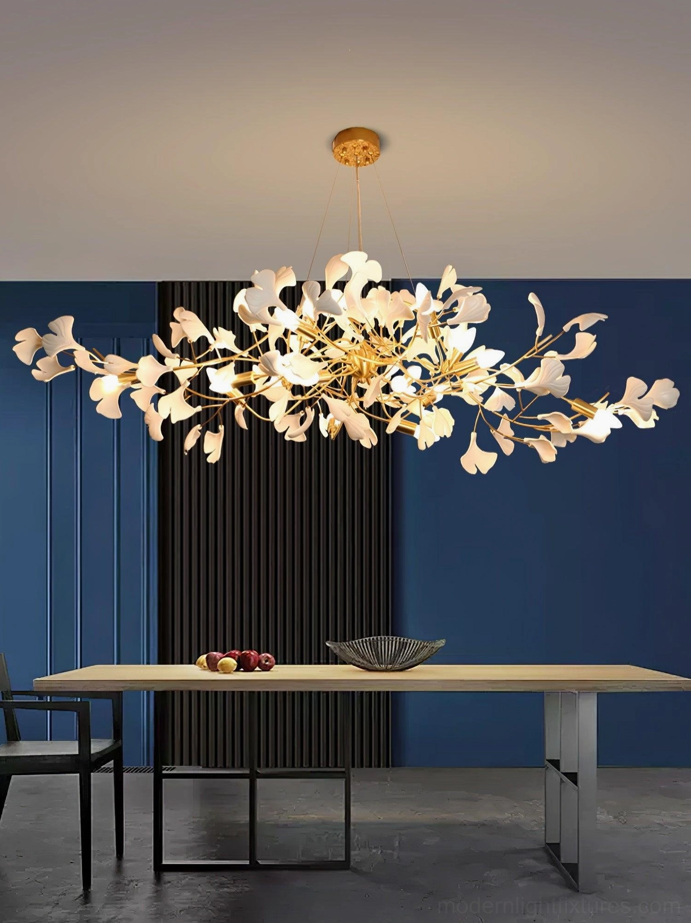 Ginkgo leaf dining chandelier installed above dining table in modern minimalist dining room with warm lighting