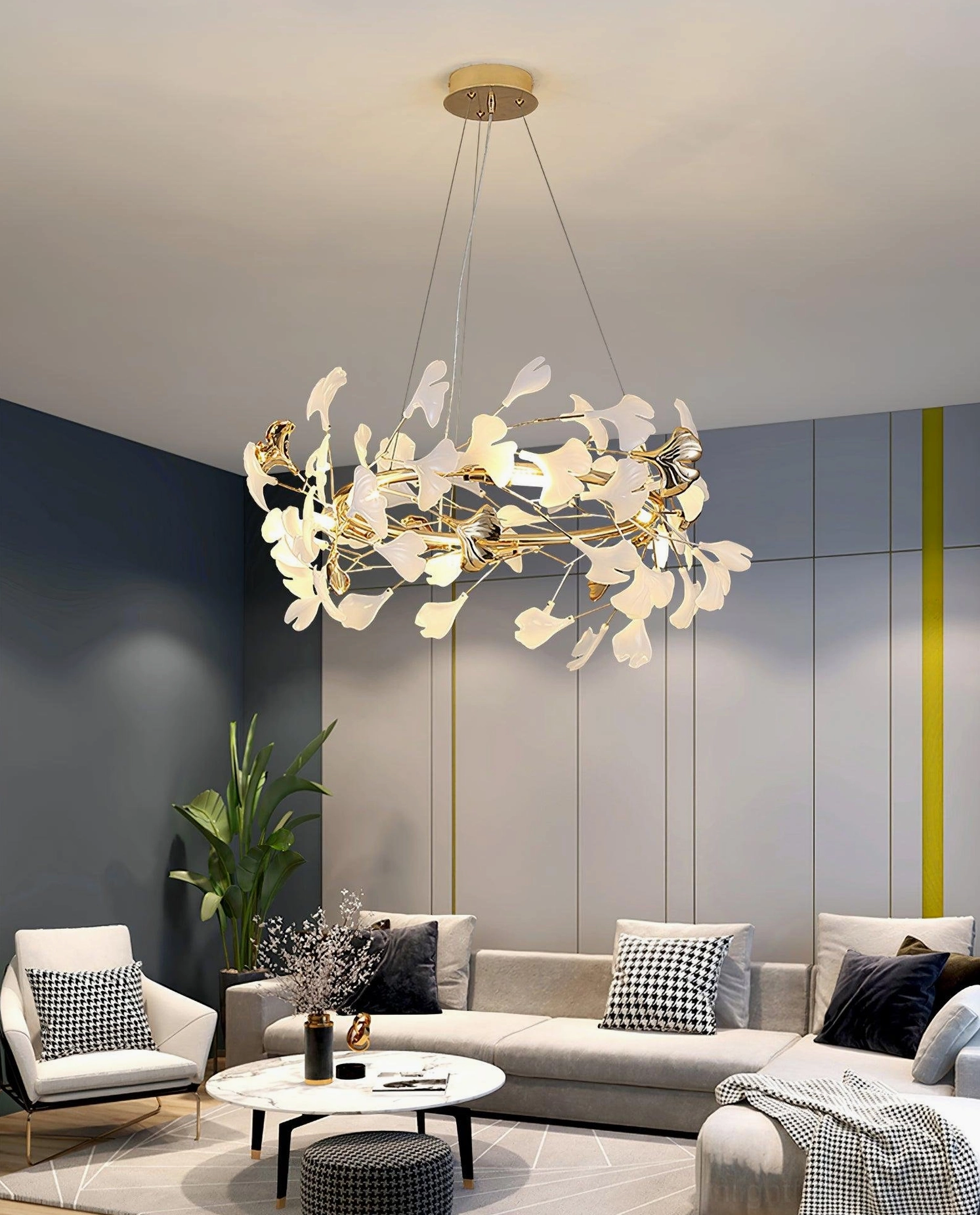 Close-up detail of white ceramic ginkgo leaves and gold metal structure on U-style chandelier