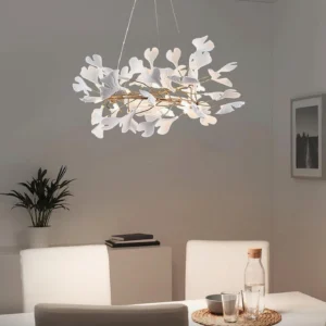 Modern ginkgo leaf pendant light in luxury dining room setting with gold frame and white ceramic accents