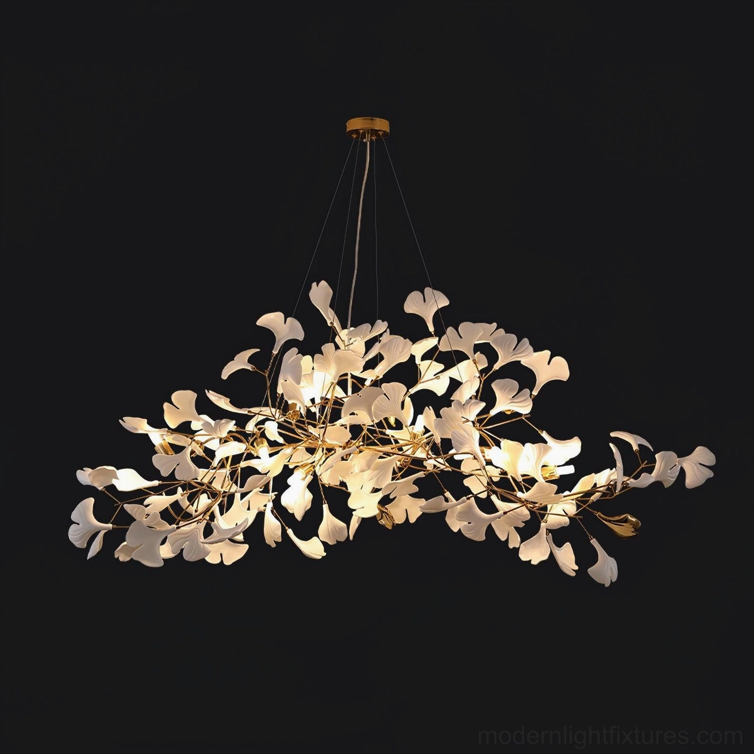 Modern ginkgo leaf chandelier with gold metal frame and white ceramic leaves illuminated on black background