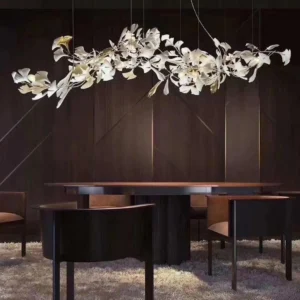 Contemporary ginkgo leaf chandelier suspended over dining table in luxury modern dining room with warm glowing ambient light