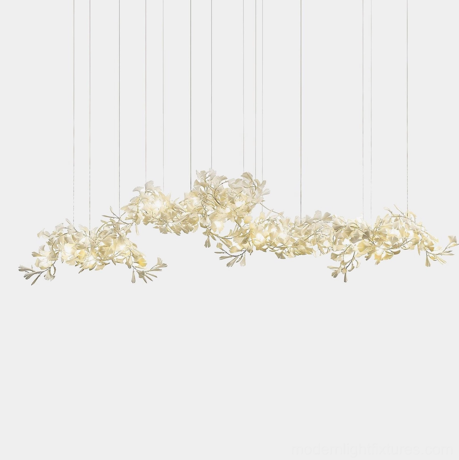 Ginkgo leaf pendant chandelier with asymmetrical cream-colored ceramic leaves arranged in sculptural formation, overhead studio view