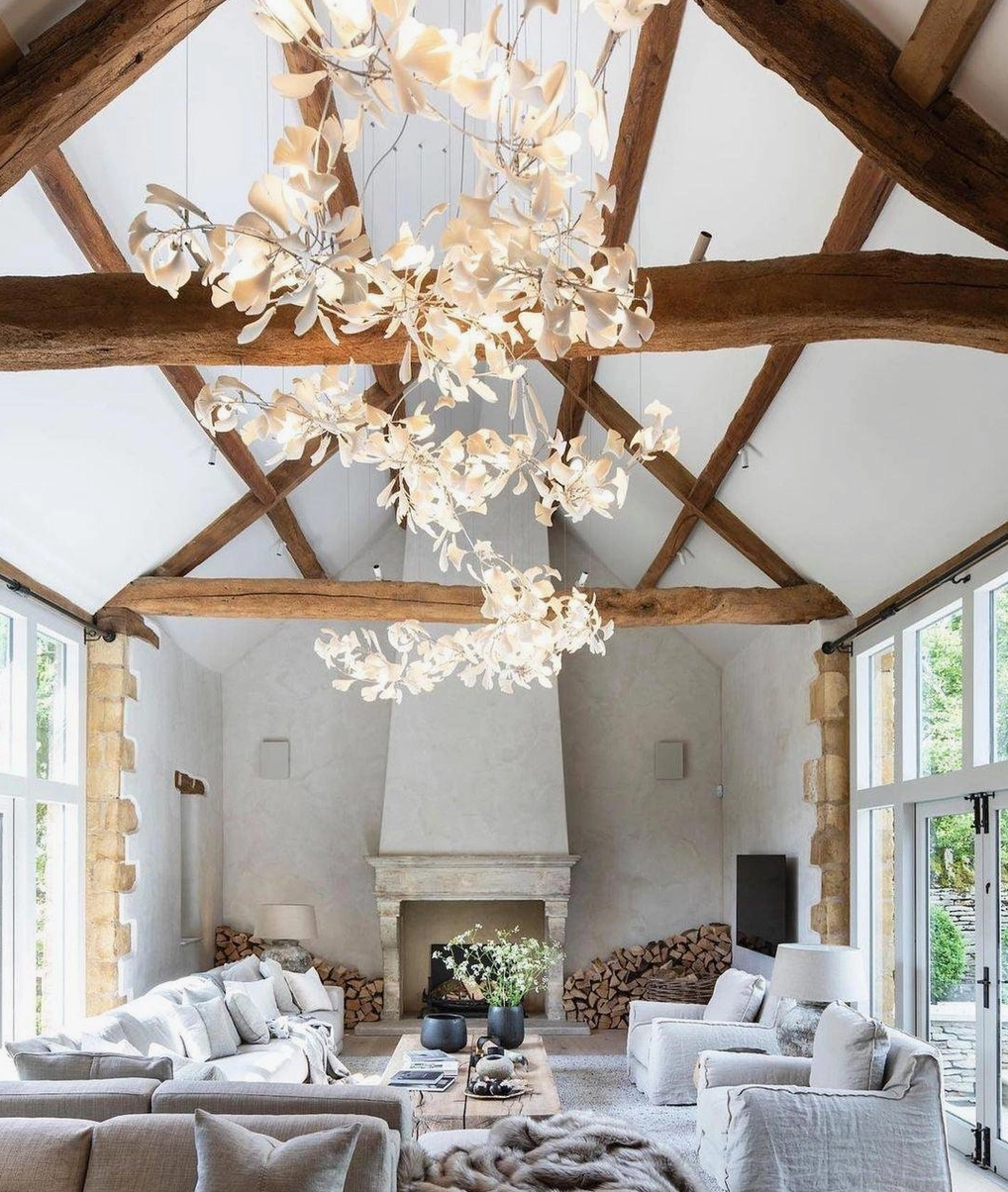 Ginkgo leaf chandelier illuminated in evening setting showing warm ambient lighting and shadow play effects