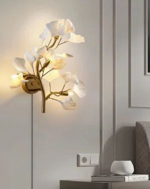 Ginkgo leaf wall sconce installed in minimalist bedroom corner with warm ambient lighting and visible power cord