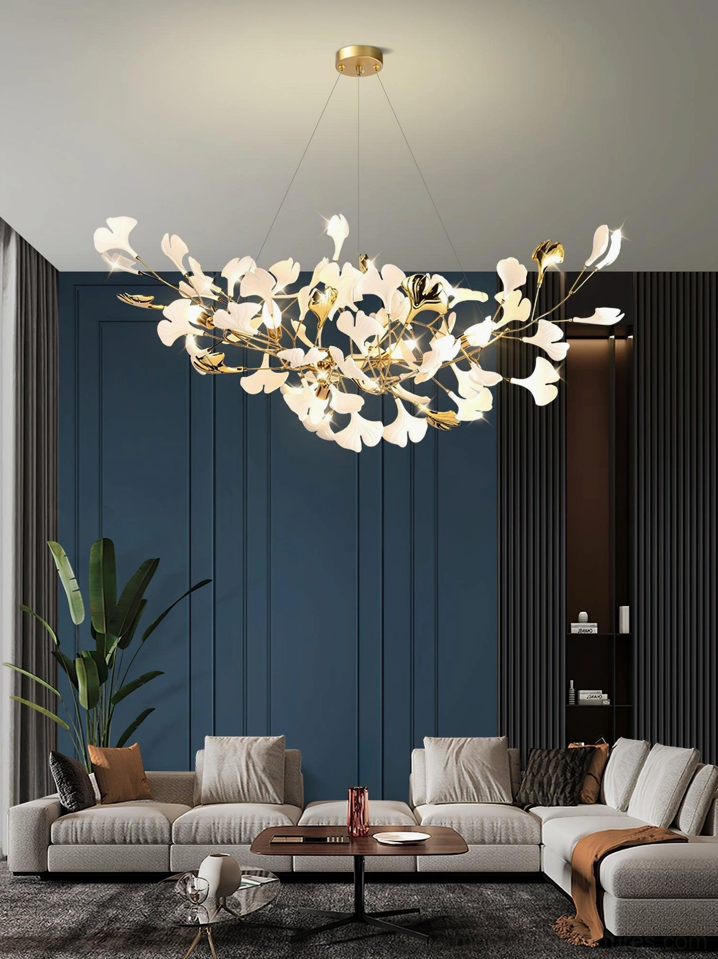 Contemporary ginkgo leaf chandelier angled view - white ceramic and gold metal in modern living room with sectional sofa