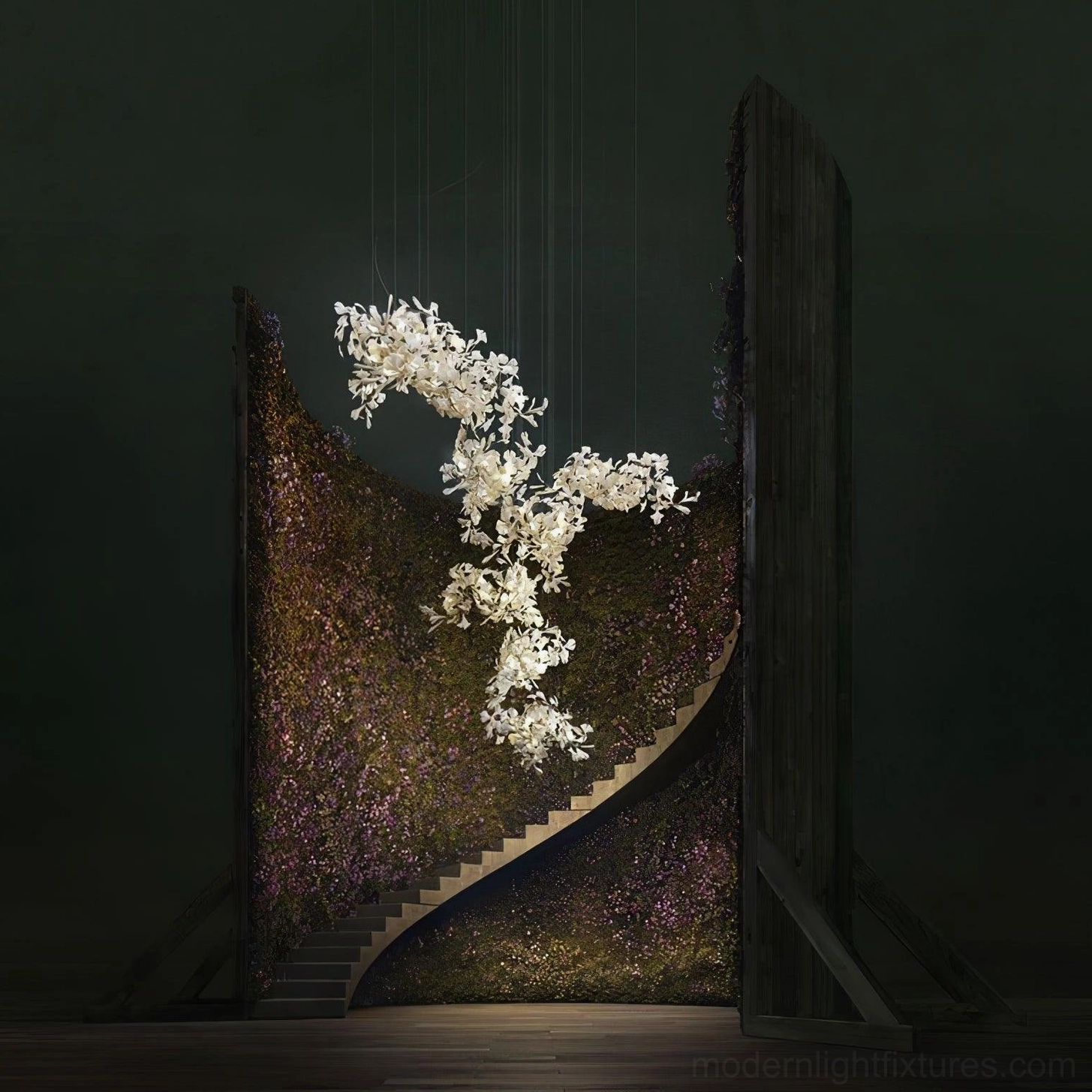 White ceramic ginkgo leaf chandelier low angle view showing cascading design in dark spiral staircase interior