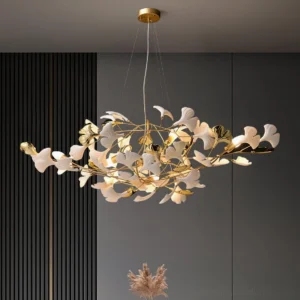 Ginkgo leaf pendant chandelier in living room overhead view - gold metal with white ceramic leaves in dark luxury interior