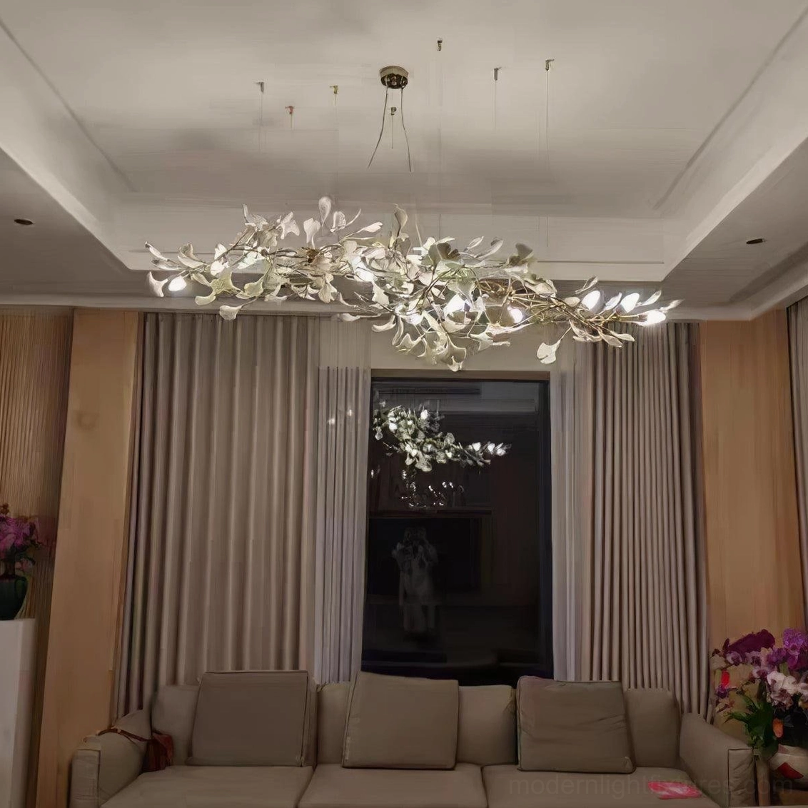 Modern ginkgo leaf pendant light with warm illumination in contemporary residential interior with natural ambiance
