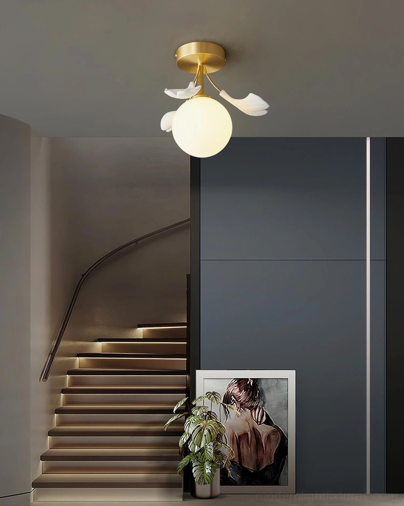 Ginkgo Rosalia brass ceiling light in residential staircase hallway with blue accent wall